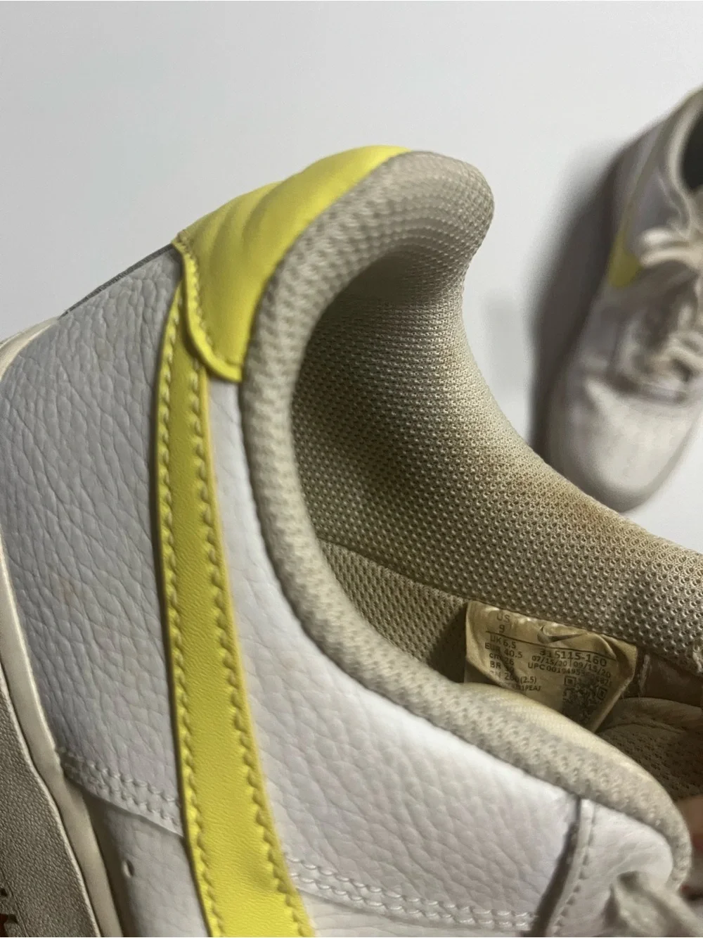 Nike White Low-Top Sneakers with Yellow Swoosh